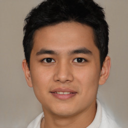 Joyful latino young-adult male with short  brown hair and brown eyes