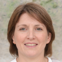 Joyful white adult female with medium  brown hair and grey eyes