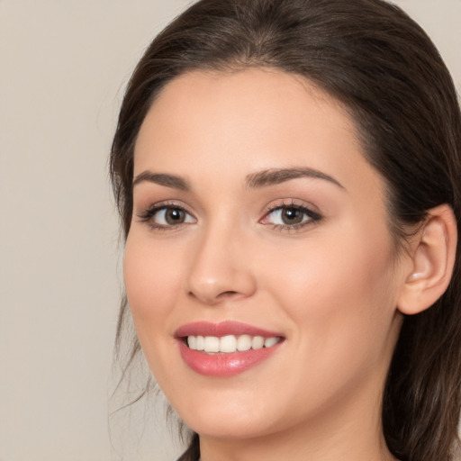 Joyful white young-adult female with medium  brown hair and brown eyes