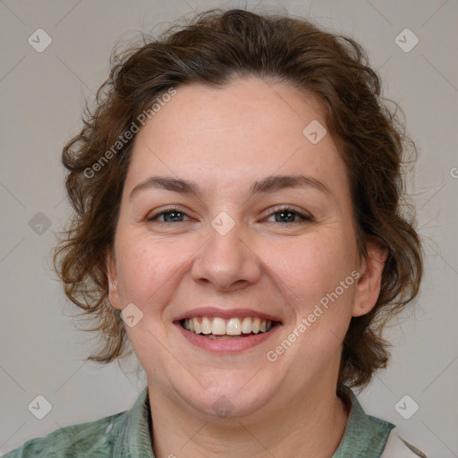 Joyful white adult female with medium  brown hair and green eyes