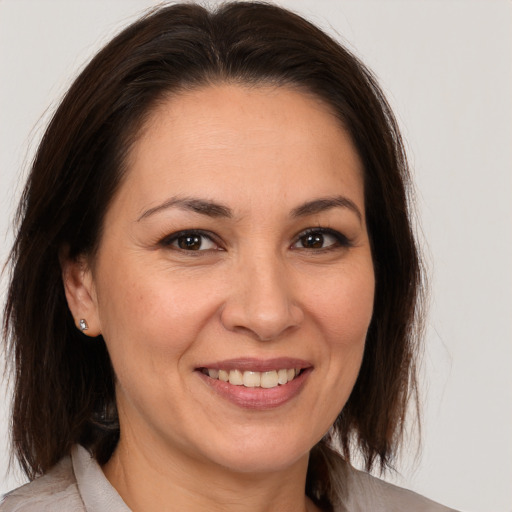 Joyful white adult female with medium  brown hair and brown eyes