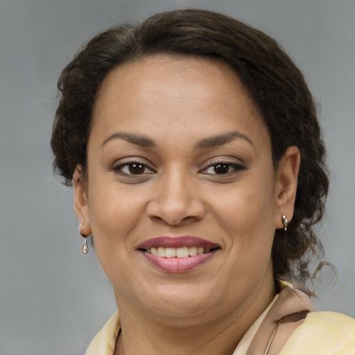 Joyful latino adult female with short  brown hair and brown eyes