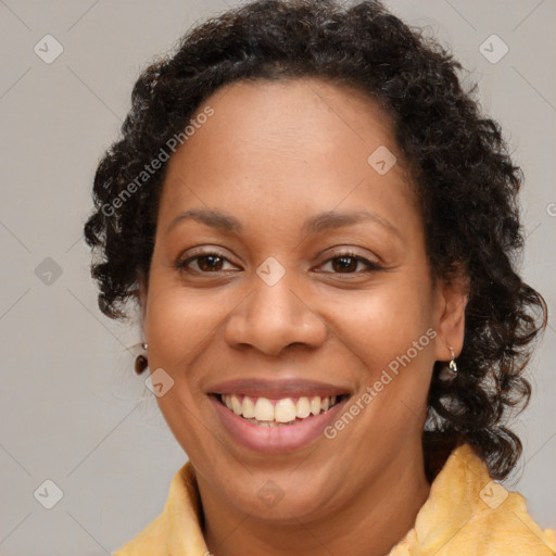 Joyful latino adult female with medium  brown hair and brown eyes