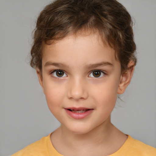 Joyful white child male with short  brown hair and brown eyes