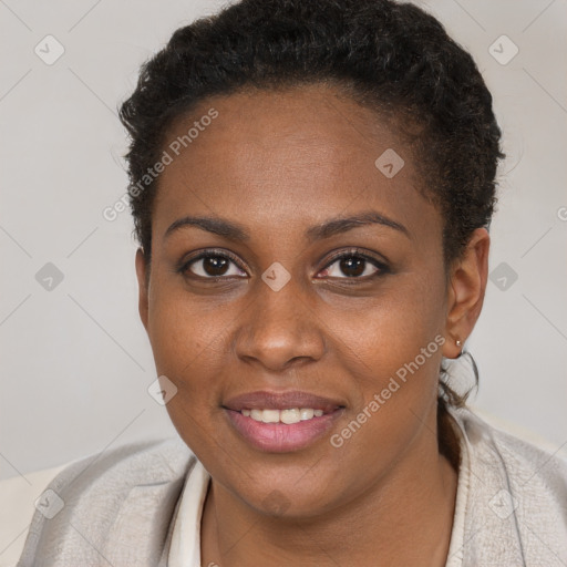 Joyful black young-adult female with short  brown hair and brown eyes