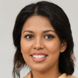 Joyful black young-adult female with medium  brown hair and brown eyes