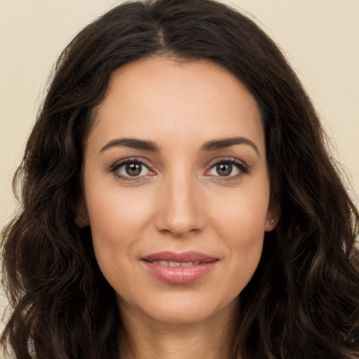 Joyful white young-adult female with long  brown hair and brown eyes