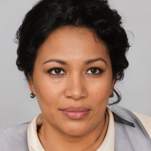 Joyful latino young-adult female with short  brown hair and brown eyes