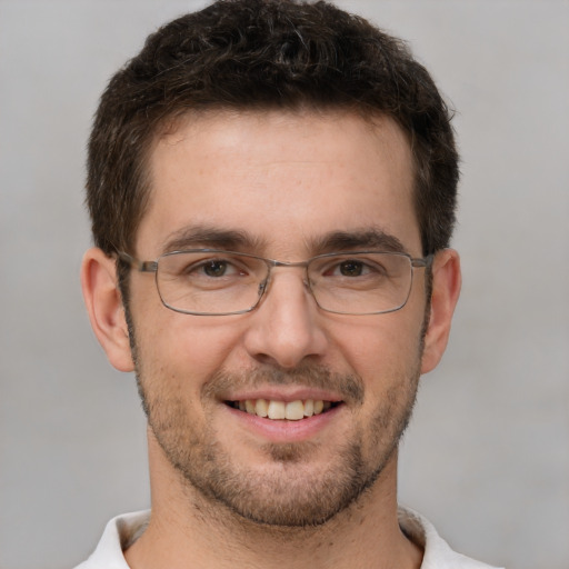 Joyful white adult male with short  brown hair and brown eyes