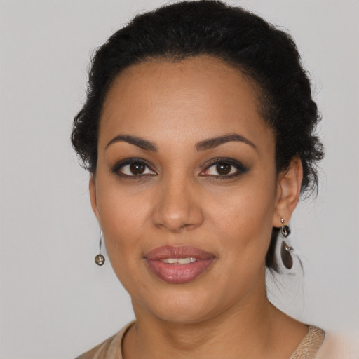 Joyful black young-adult female with medium  black hair and brown eyes