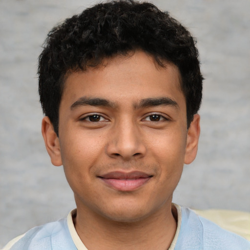 Joyful latino young-adult male with short  brown hair and brown eyes