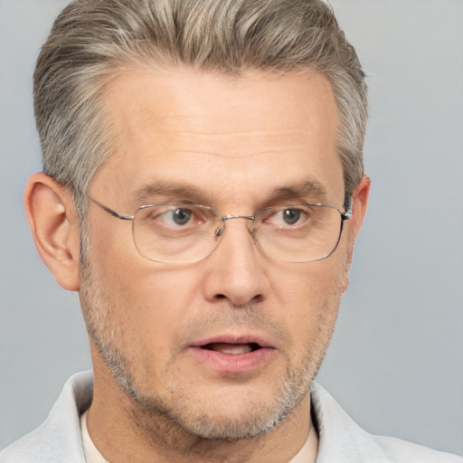 Neutral white middle-aged male with short  gray hair and brown eyes