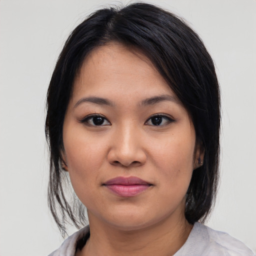 Joyful asian young-adult female with medium  black hair and brown eyes