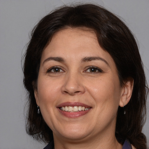 Joyful white adult female with medium  brown hair and brown eyes