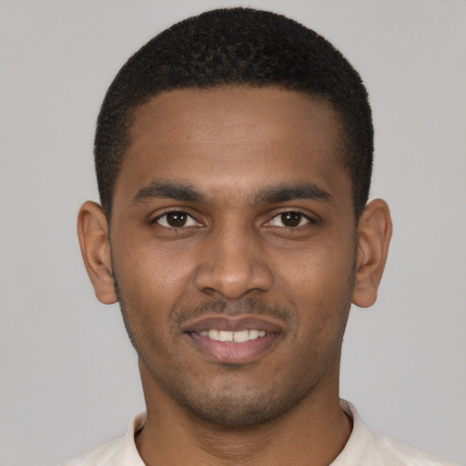 Joyful black young-adult male with short  black hair and brown eyes