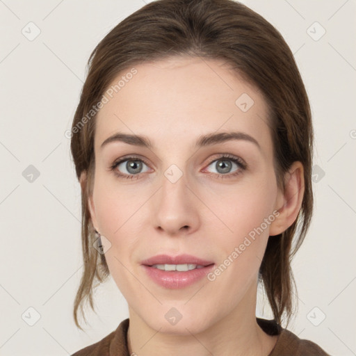 Joyful white young-adult female with medium  brown hair and grey eyes