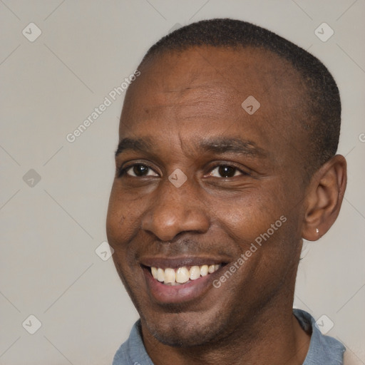 Joyful black adult male with short  brown hair and brown eyes