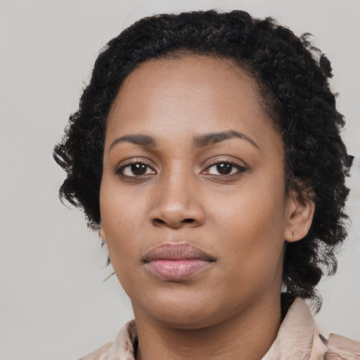 Joyful black young-adult female with medium  black hair and brown eyes