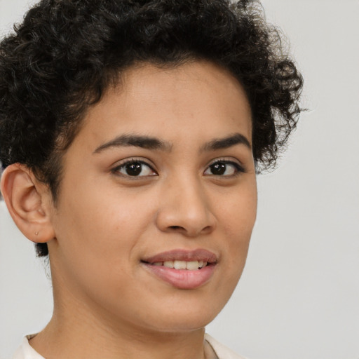 Joyful latino young-adult female with short  brown hair and brown eyes