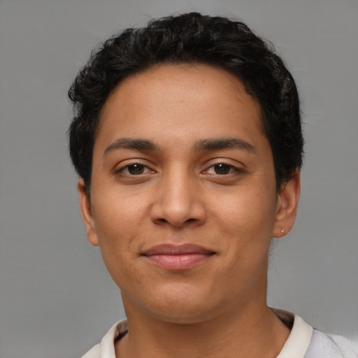 Joyful latino young-adult female with short  black hair and brown eyes