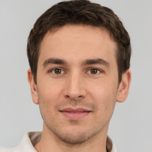 Joyful white young-adult male with short  brown hair and brown eyes