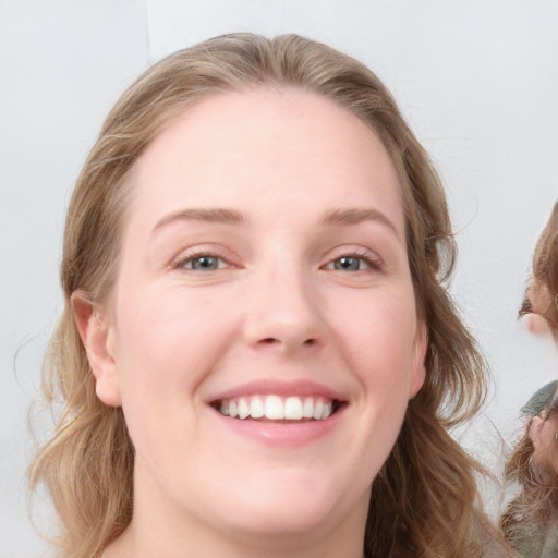 Joyful white young-adult female with medium  brown hair and blue eyes