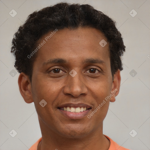 Joyful black adult male with short  brown hair and brown eyes