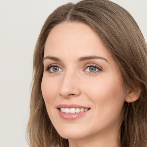 Joyful white young-adult female with long  brown hair and grey eyes