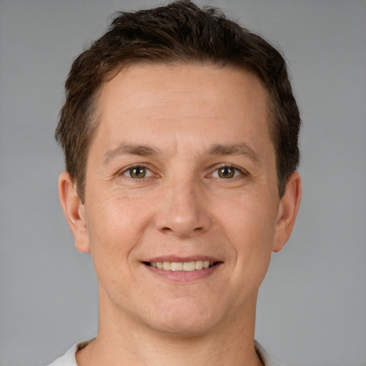 Joyful white adult male with short  brown hair and brown eyes