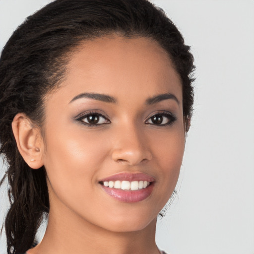 Joyful latino young-adult female with long  brown hair and brown eyes