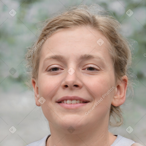 Joyful white young-adult female with medium  brown hair and blue eyes