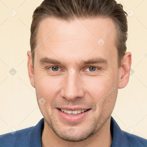 Joyful white young-adult male with short  brown hair and brown eyes