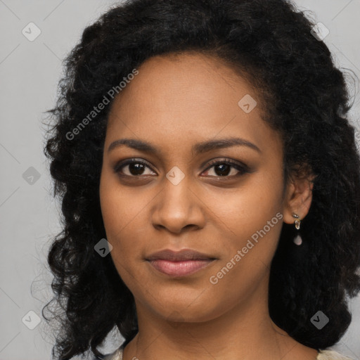 Joyful black young-adult female with long  black hair and brown eyes