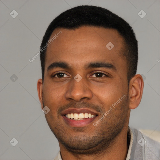 Joyful black young-adult male with short  black hair and brown eyes