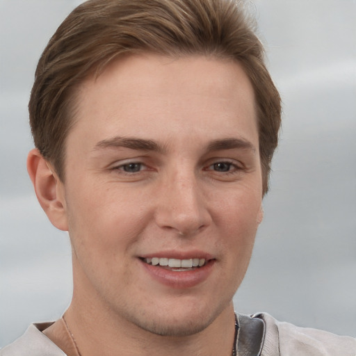 Joyful white young-adult female with short  brown hair and grey eyes