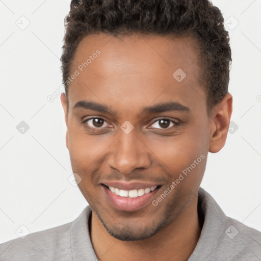 Joyful black young-adult male with short  brown hair and brown eyes