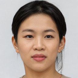 Joyful asian young-adult female with medium  brown hair and brown eyes