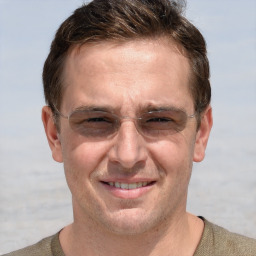 Joyful white adult male with short  brown hair and grey eyes