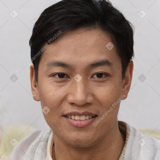 Joyful asian young-adult male with short  brown hair and brown eyes