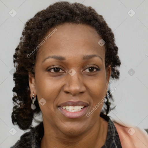 Joyful black adult female with long  brown hair and brown eyes