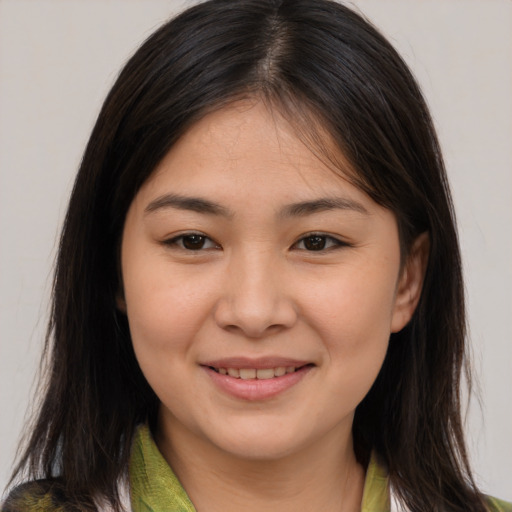 Joyful asian young-adult female with medium  brown hair and brown eyes