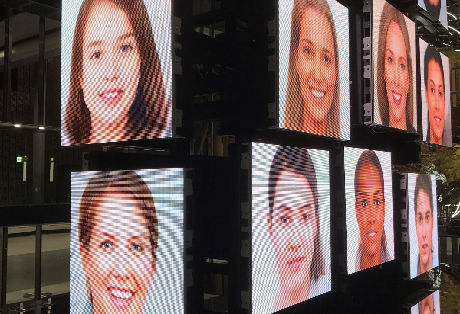 LED display showing AI-generated diverse faces at Miraikan science museum exhibition Tokyo