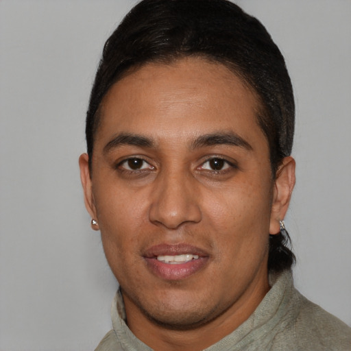 Joyful latino young-adult male with short  black hair and brown eyes