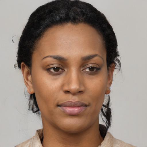 Joyful black young-adult female with medium  black hair and brown eyes