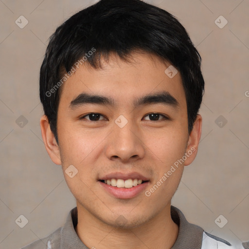 Joyful asian young-adult male with short  black hair and brown eyes