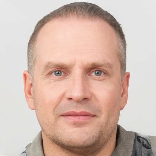 Joyful white adult male with short  brown hair and grey eyes