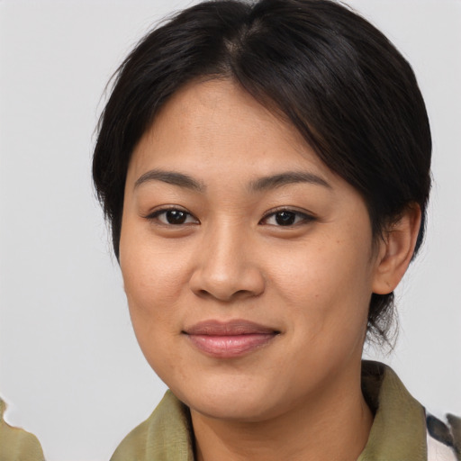 Joyful asian young-adult female with medium  brown hair and brown eyes