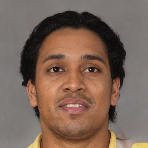 Neutral latino adult male with short  brown hair and brown eyes