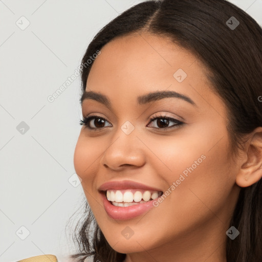 Joyful latino young-adult female with long  brown hair and brown eyes