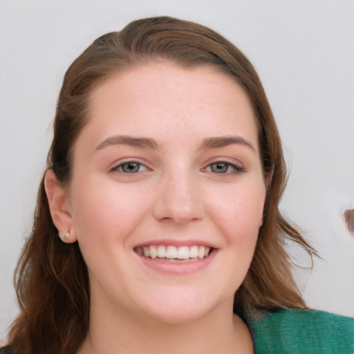 Joyful white young-adult female with long  brown hair and blue eyes